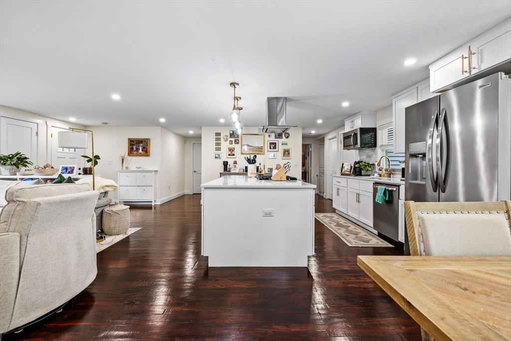 10 Walker Road Topsfield, MA 01983 - Photo 11 of 41 a kitchen with stainless steel appliances kitchen island granite countertop a refrigerator a stove top oven and white cabinets