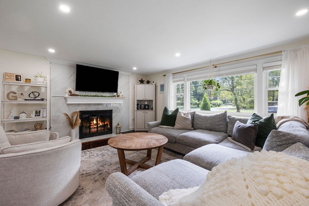 10 Walker Road Topsfield, MA 01983 - Photo 12 of 41 a living room with furniture a fireplace and a flat screen tv