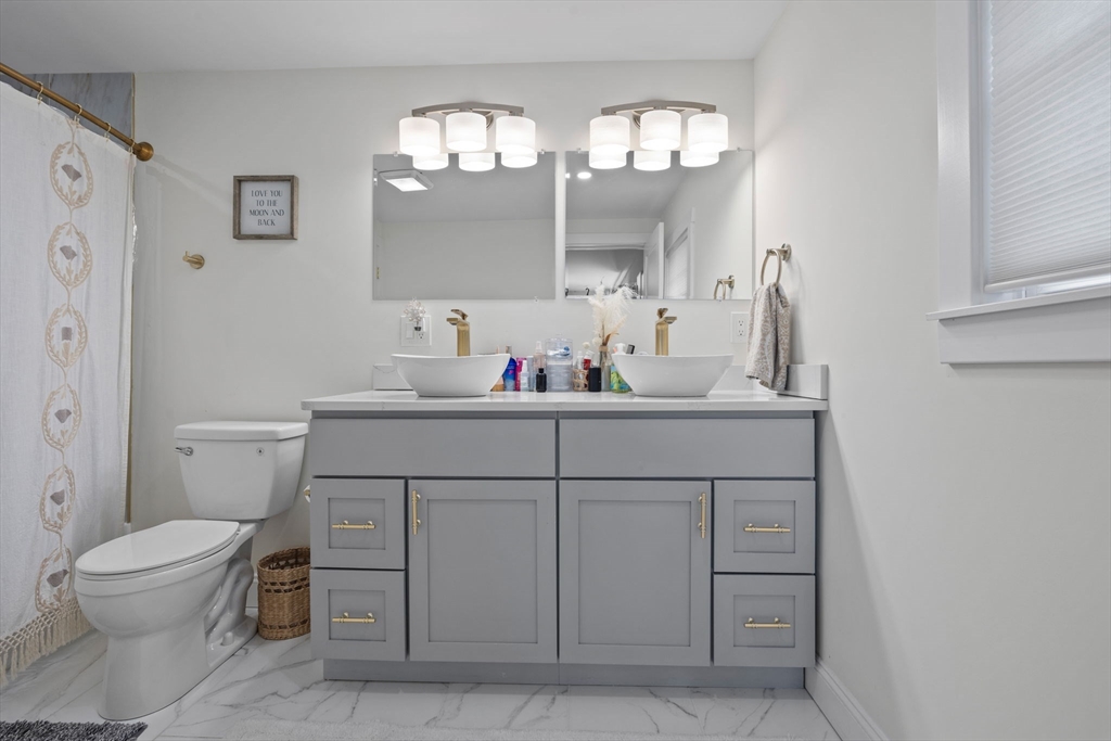 10 Walker Road Topsfield, MA 01983 - Photo 16 of 41 a bathroom with a sink a toilet and a mirror