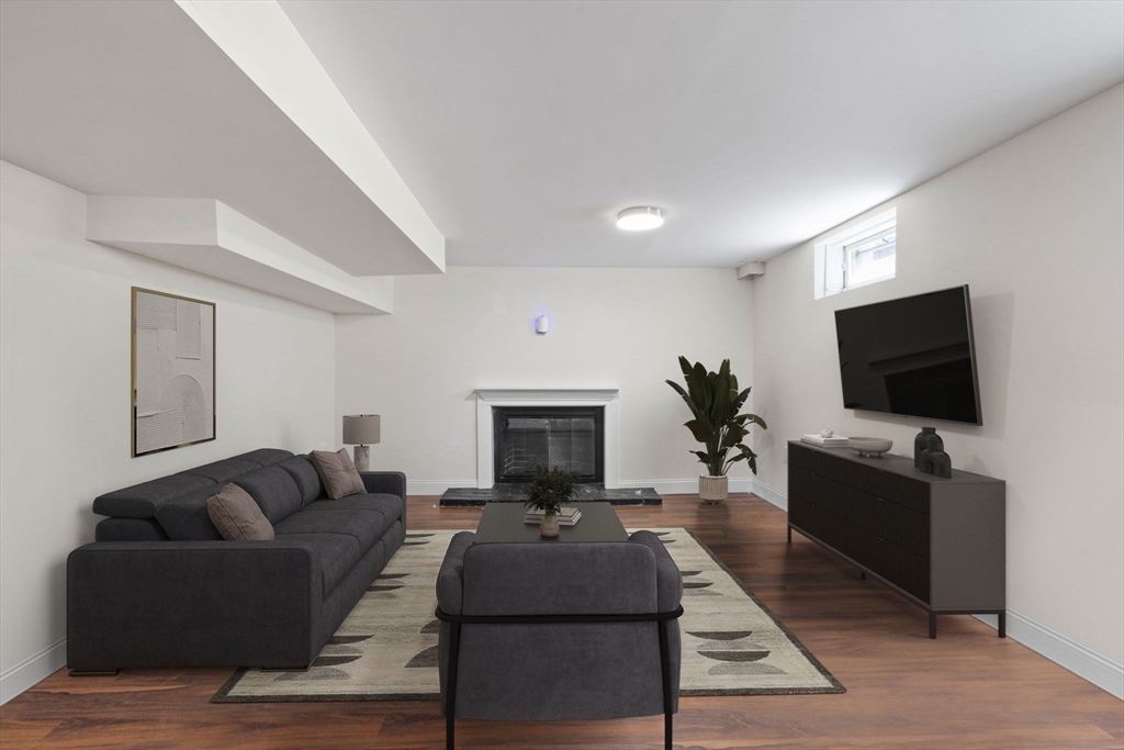 10 Walker Road Topsfield, MA 01983 - Photo 29 of 41 a living room with furniture a flat screen tv and a fireplace