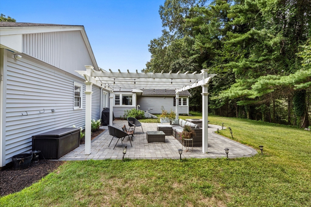 10 Walker Road Topsfield, MA 01983 - Photo 37 of 41 a view of a patio with table and chairs potted plants and large tree