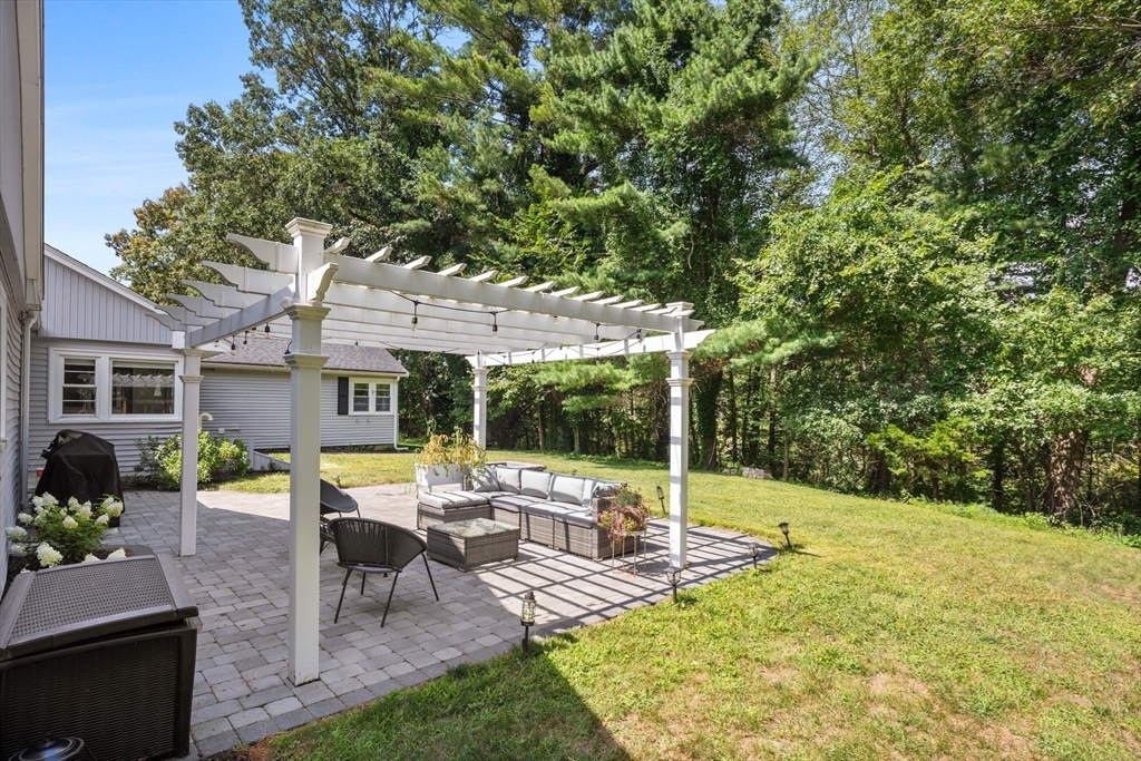 10 Walker Road Topsfield, MA 01983 - Photo 38 of 41 a view of a patio with table and chairs under an umbrella