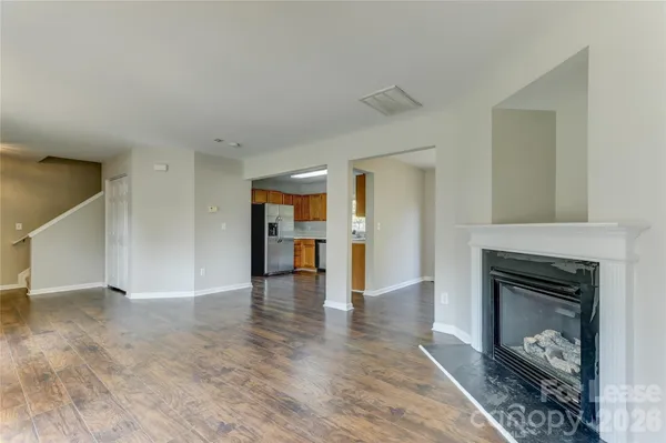 a kitchen with stainless steel appliances granite countertop a refrigerator a sink a stove and island