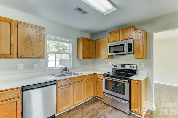 a kitchen with a sink and steel appliances