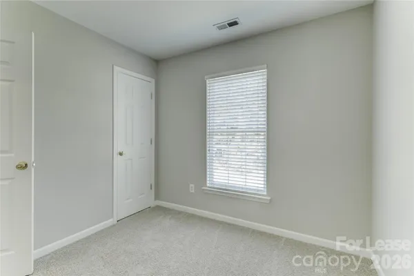 a view of an empty room and a window