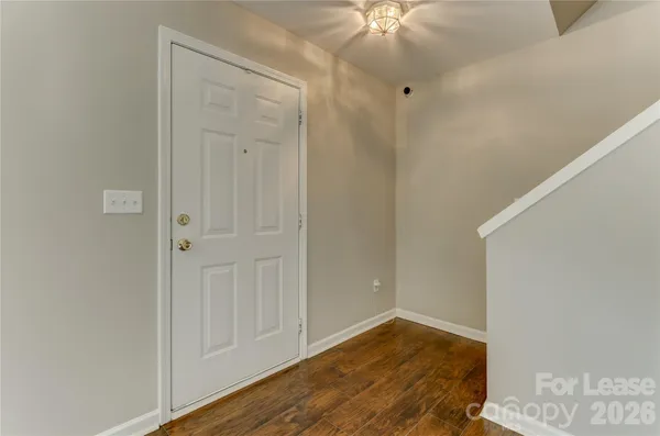a view of an entryway with wooden floor