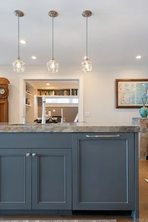 a view of a kitchen with granite countertop cabinets and wooden floor
