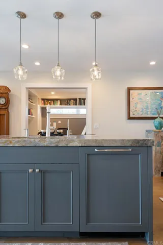 a view of a kitchen with granite countertop cabinets and wooden floor