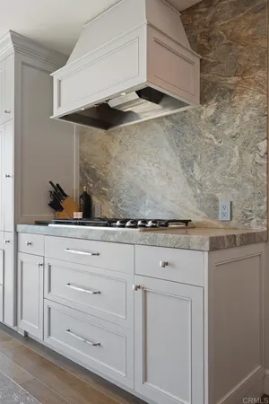 a view of white cabinets and sink