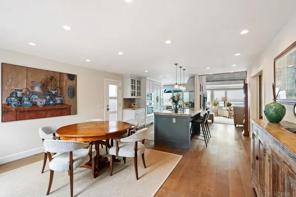 a dining room with furniture and wooden floor