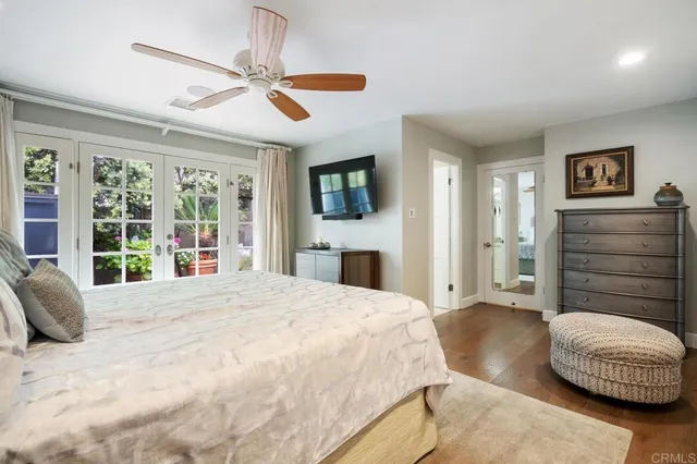 a spacious bedroom with a bed and a dresser