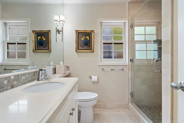 a bathroom with a granite countertop sink toilet and shower