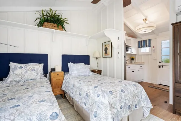 a bedroom with a bed and a potted plant