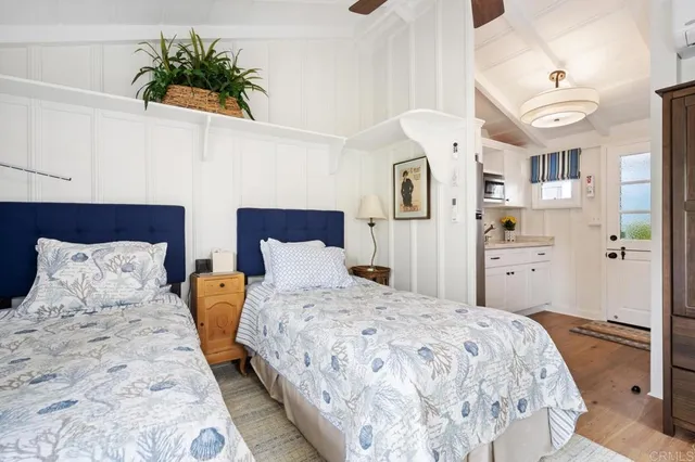 a bedroom with a bed and a potted plant