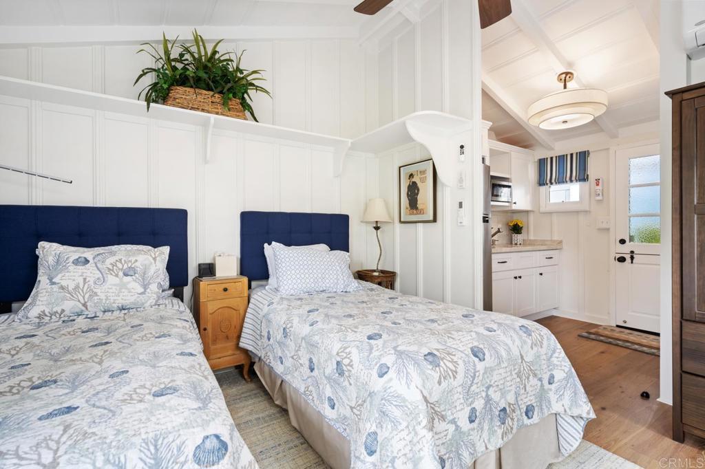 2028 Ocean Front Del Mar, CA 92014 - Photo 27 of 32 a bedroom with a bed and a potted plant