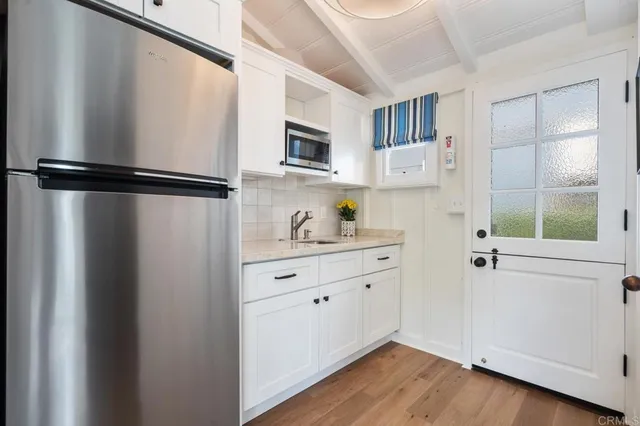 a kitchen with stainless steel appliances granite countertop a refrigerator and a sink