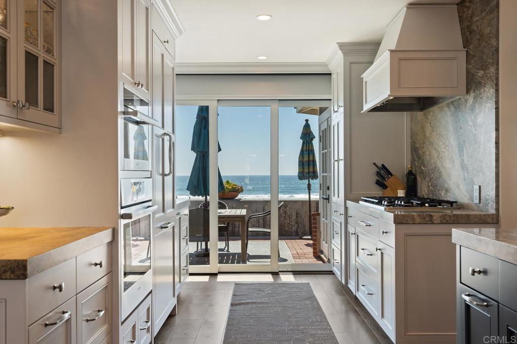 2028 Ocean Front Del Mar, CA 92014 - Photo 5 of 32 a kitchen with stainless steel appliances granite countertop a stove and a refrigerator