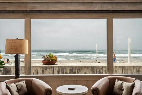 a living room with a couch and a floor to ceiling window