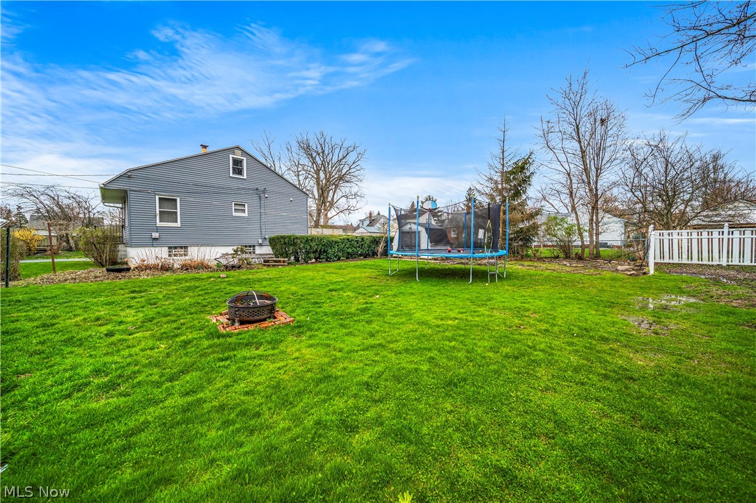 1588 Biltmore Road Cleveland, OH 44124 - Photo 41 of 43 View of yard featuring an outdoor fire pit and a trampoline