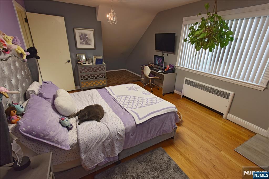 585 Monroe Place Ridgefield, NJ 07657 - Photo 18 of 28 a bed sitting in a bedroom next to a window with pc on the table