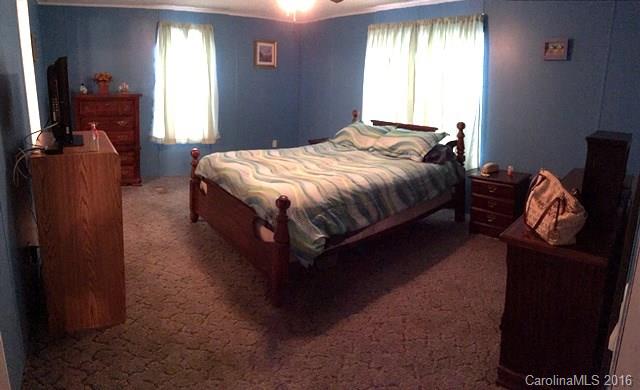 5800 Laney Rogers Road Monroe, NC 28112 - Photo 16 of 21 a bedroom with a bed and wooden floor