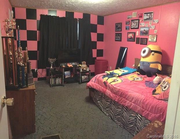 5800 Laney Rogers Road Monroe, NC 28112 - Photo 21 of 21 a bedroom with bed and a book shelf