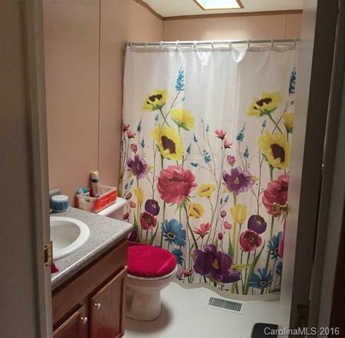 5800 Laney Rogers Road Monroe, NC 28112 - Photo 5 of 21 a bathroom with a sink and mirror with shower curtain