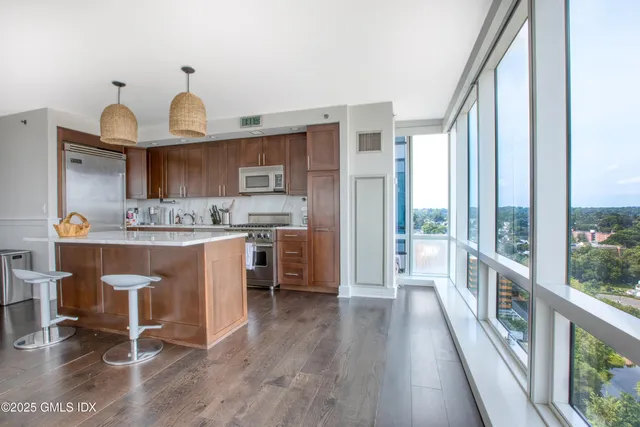 a open kitchen with granite countertop a sink cabinets and wooden floor