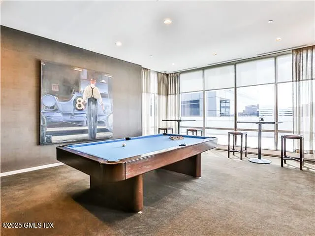 a room with pool table and windows