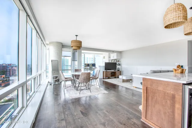 a very nice looking living room with a large window and furniture