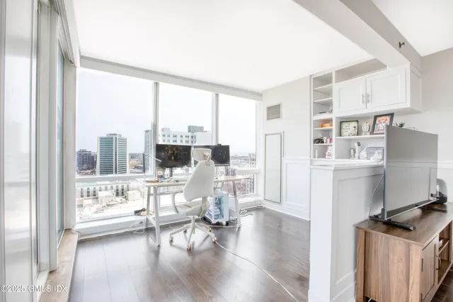 a living room with furniture and a large window