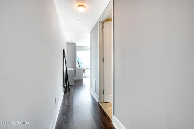 a view of a hallway with wooden floor