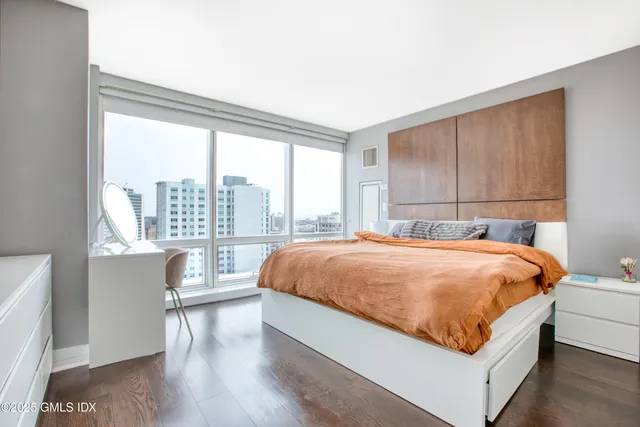 a bed sitting in a bedroom next to a window