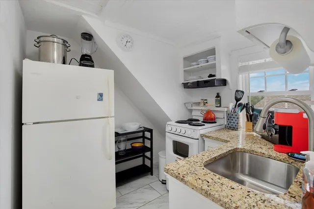 a kitchen with refrigerator a sink and cabinets