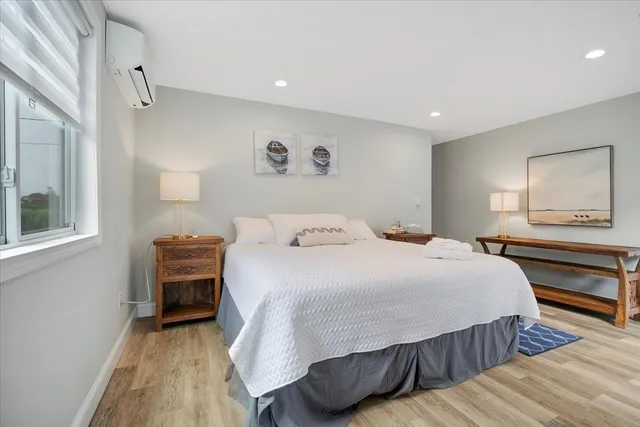 a view of a patio with couches chairs and wooden floor