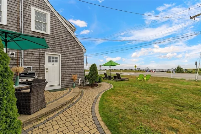 a view of a backyard with plants and lake view