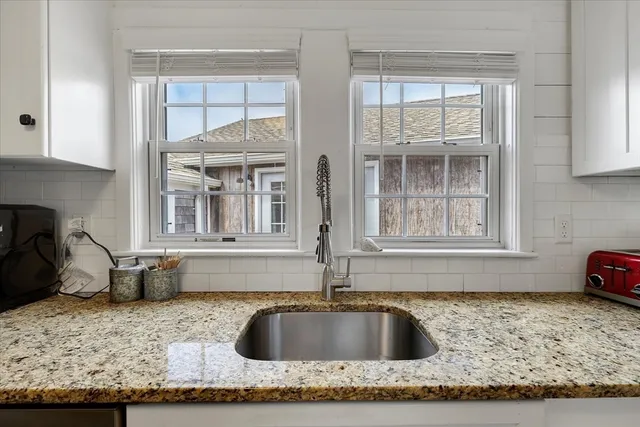 a kitchen with granite countertop a sink and a counter top space