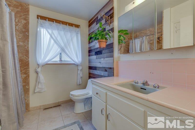 710 West 12th Street Reno, NV 89503 - Photo 17 of 25 a bathroom with a sink a toilet and a mirror