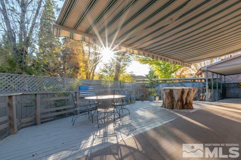 710 West 12th Street Reno, NV 89503 - Photo 25 of 25 a view of a patio with table and chairs with wooden floor and fence