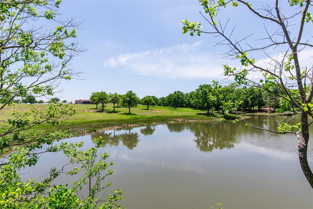 2043 Huddleston Road Sunset, TX 76270 - Photo 23 of 36 a view of a lake with a big yard