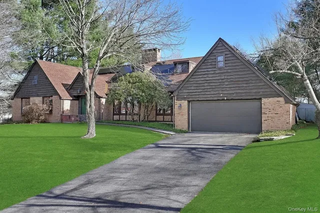a front view of a house with a garden and yard