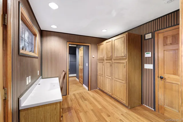 a view of a room with wooden floor and door