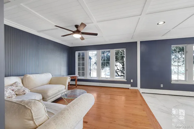 a living room with furniture a fireplace and a piano