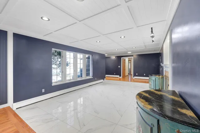 a large kitchen with a large window and stainless steel appliances