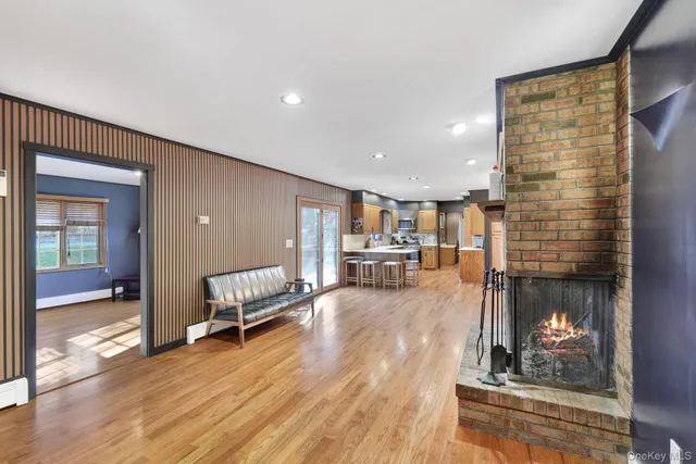 a view of a hallway with wooden floor and glass door