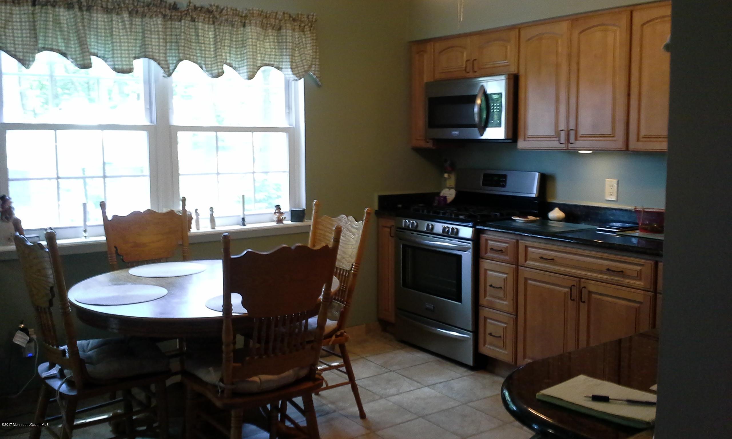 478 Rena Court Brick, NJ 08724 - Photo 4 of 13 a kitchen with a table chairs and window