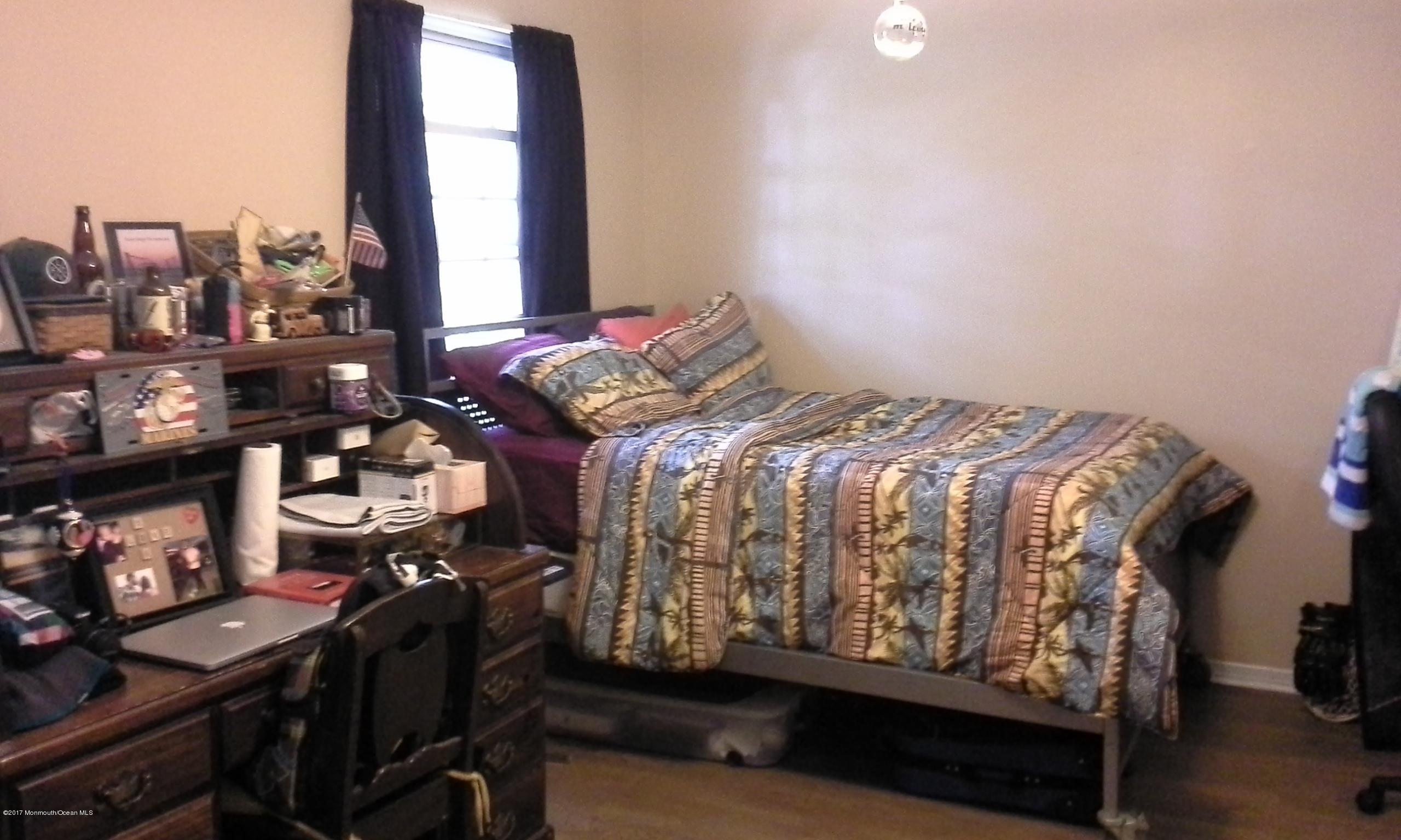 478 Rena Court Brick, NJ 08724 - Photo 9 of 13 a bed sitting in a bedroom next to a window
