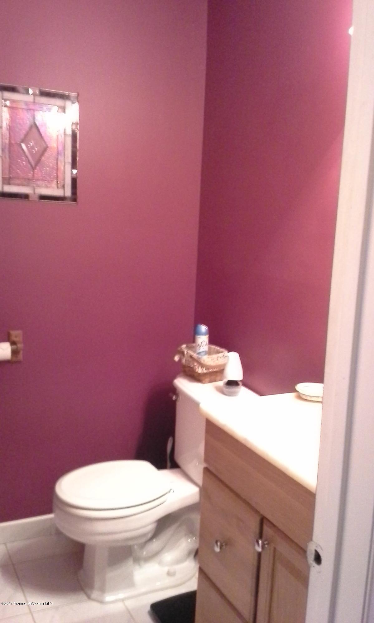 478 Rena Court Brick, NJ 08724 - Photo 10 of 13 a white toilet sitting next to a bathroom sink