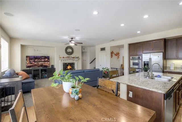 a living room with fireplace furniture and a wooden floor