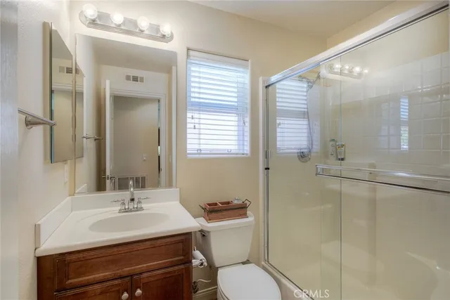 a bathroom with a sink toilet a mirror and shower